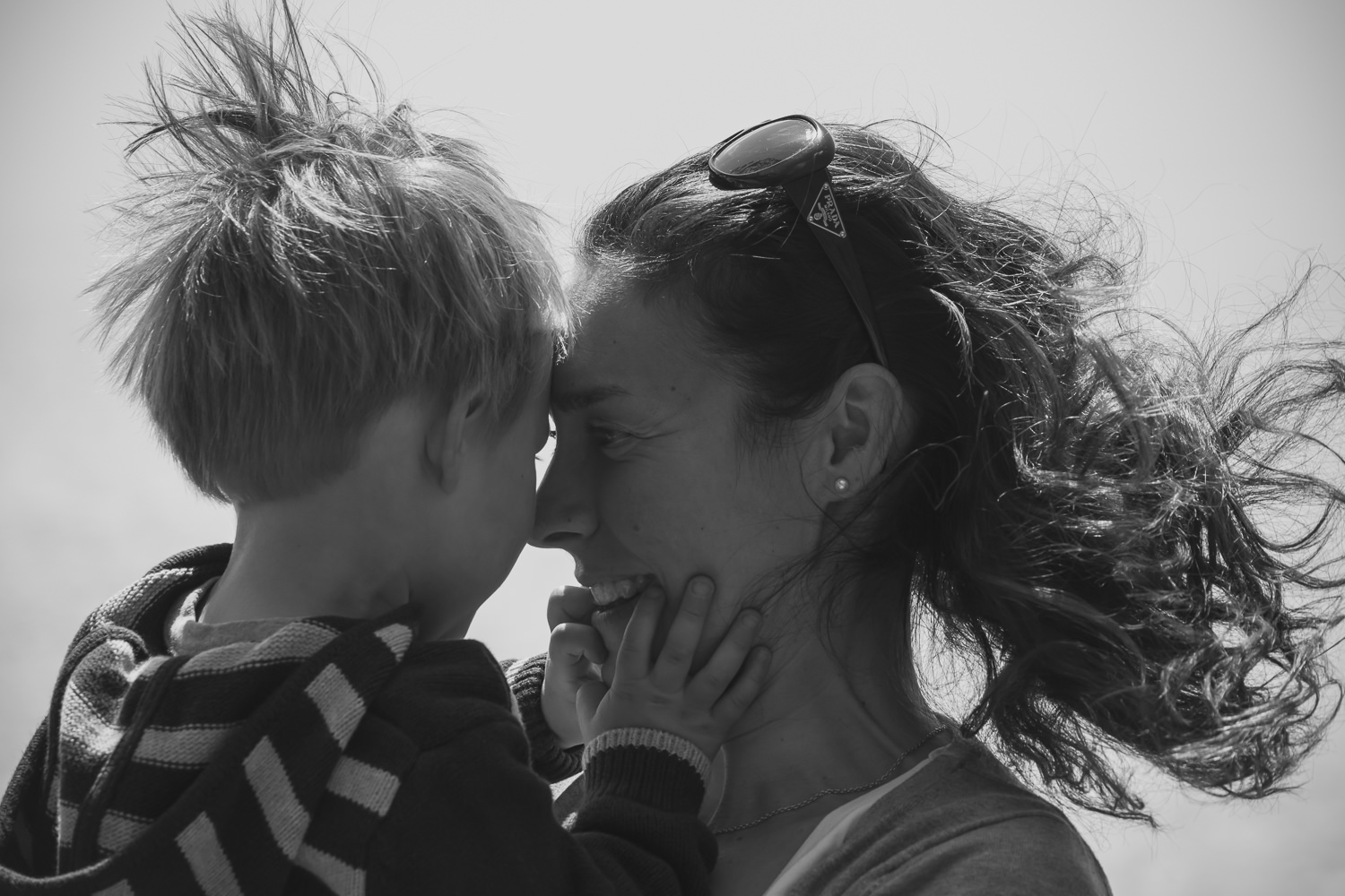 A sweet and tender moment: Mother and son share butterfly kisses. 