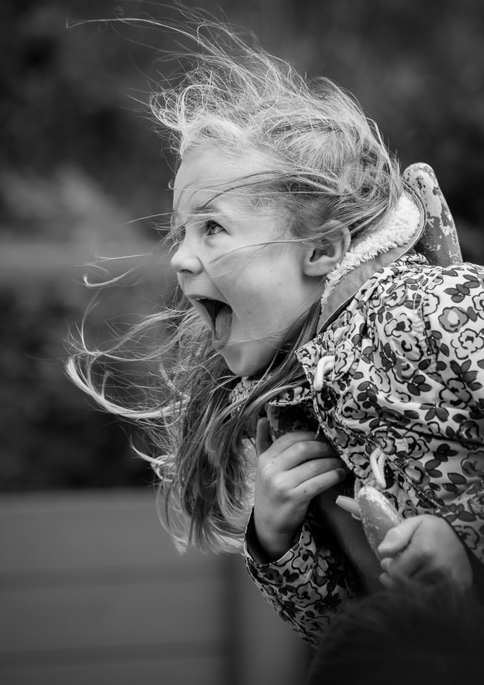 Girl laughing into the wind